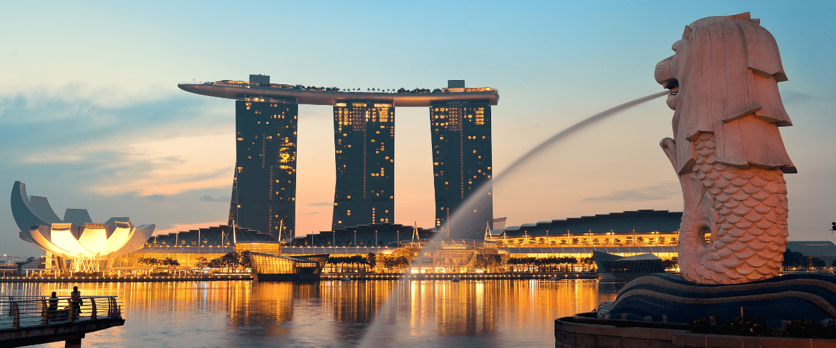 Singapore skyline at dusk with Marina Bay Sands and the Merlion